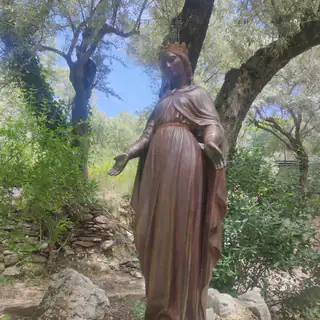 Bronze statue of the Virgin Mary among trees at Meryemana