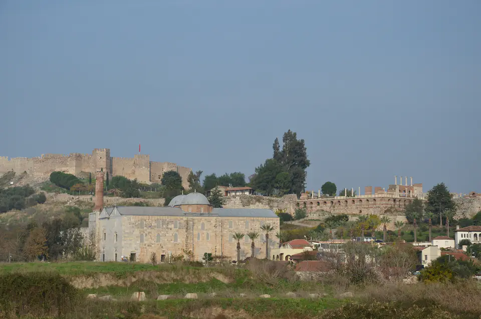 The İsa Bey Mosque seen across fields, with Ayasuluk Castle behind