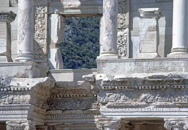 Carved window frames, columns and cornices on the upper storey of the Library of Celsus