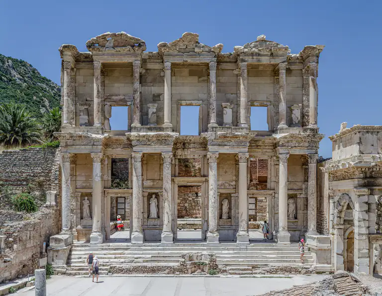 The complete Library of Celsus façade and its broad steps in sunlight