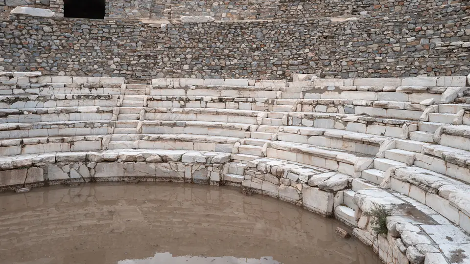 The curved lower rows of marble seats in the Odeon