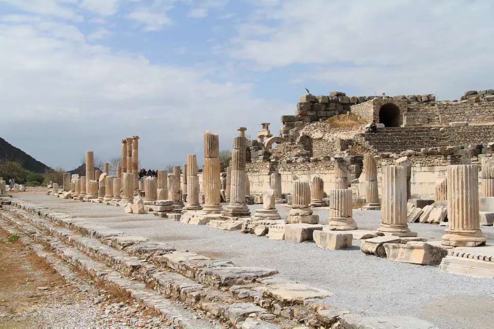 Rows of column stumps along the basilica stoa of the State Agora, with the Odeon behind